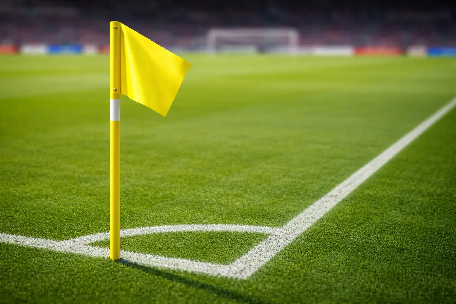 Banderín de córner en campo de fútbol con césped verde y líneas blancas